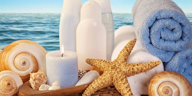 skin moisturizer and other products on the beach