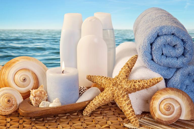 skin moisturizer and other products on the beach